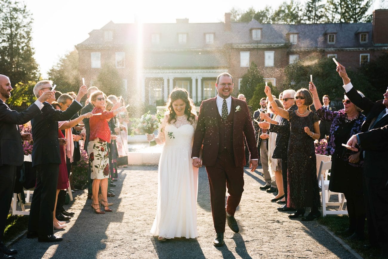 A documentary photograph featured in the best of wedding photography of 2019 showing a couple walking down the aisle with lavender in the air