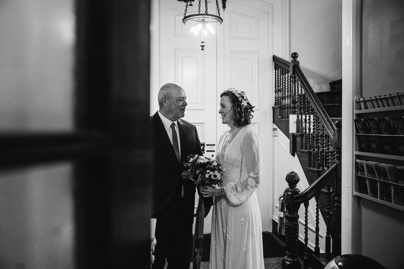 A documentary photograph featured in the best of wedding photography of 2019 showing a father and daughter sharing a special moment before the walk up the aisle