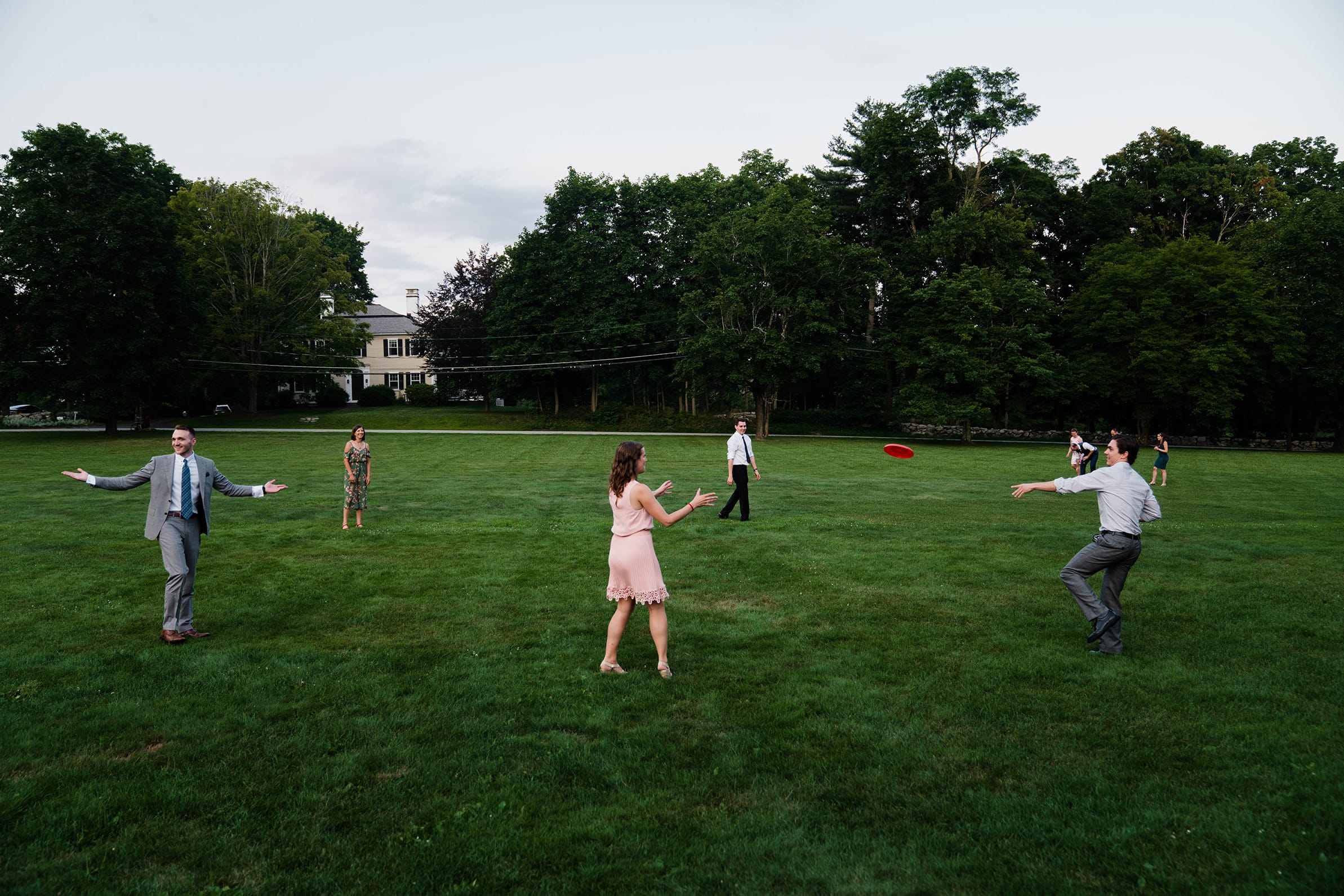 A documentary photograph featured in the best of wedding photography of 2019 showing guests playing frisbee.