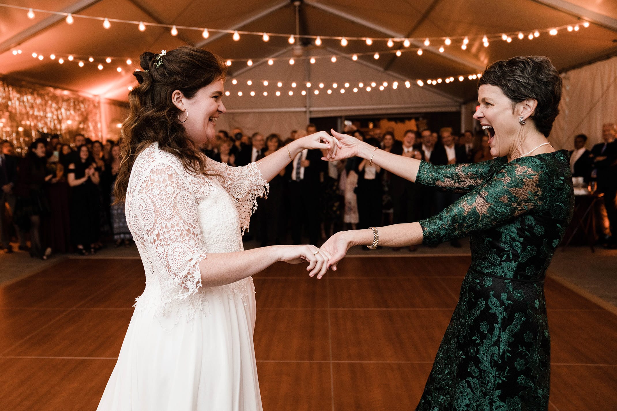 A documentary photograph featured in the best of wedding photography of 2019 showing a mother of bride and bride sharing a dance.
