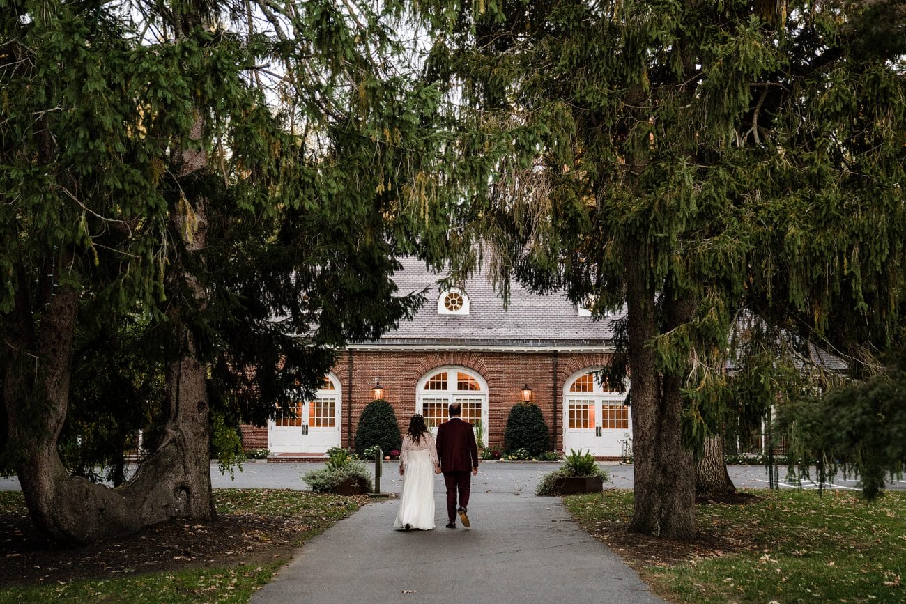 A documentary photograph featured in the best of wedding photography of 2019 showing a couple walking to their wedding reception