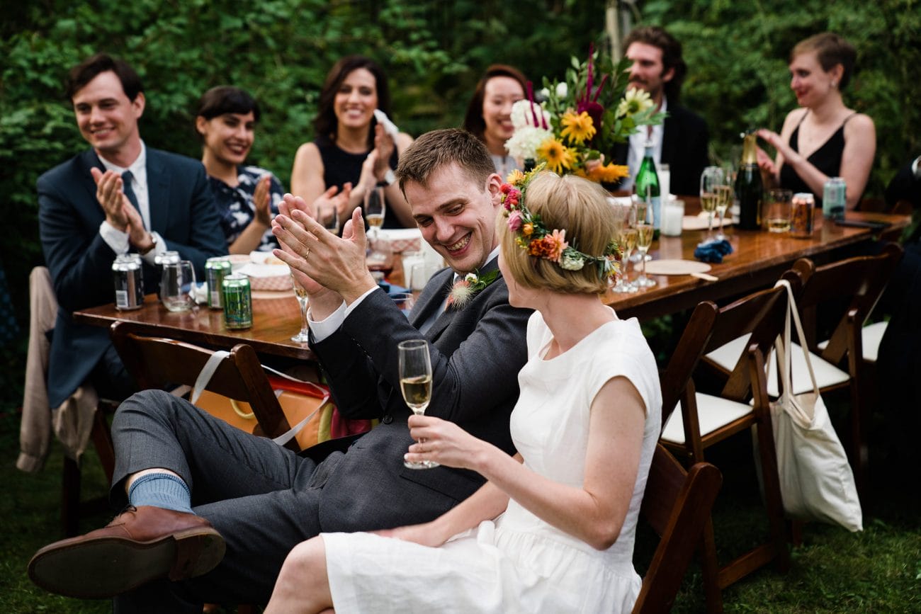 A documentary photograph featured in the best of wedding photography of 2019 showing a couple laughing during their wedding toasts