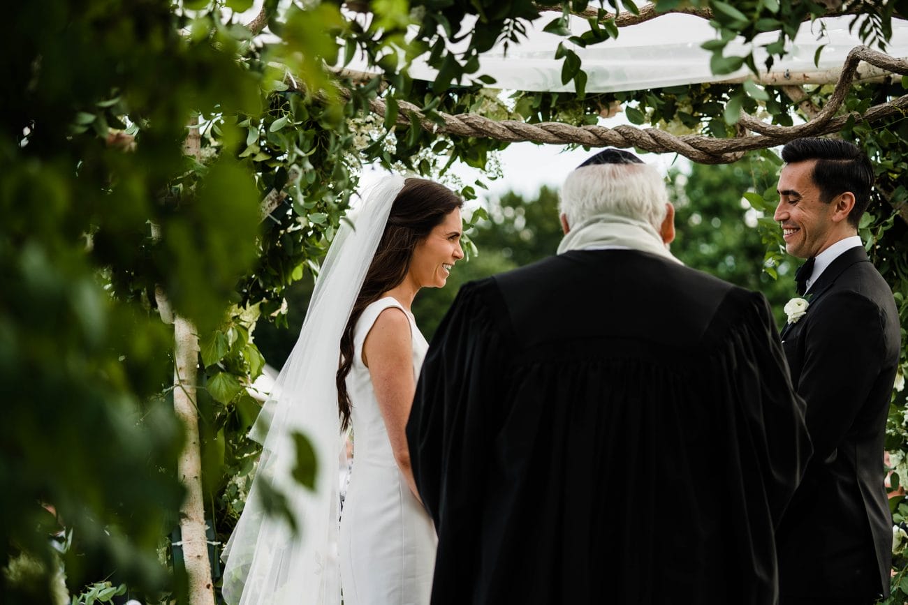 A documentary photograph featured in the best of wedding photography of 2019 showing a bride and groom smiling during their wedding ceremony