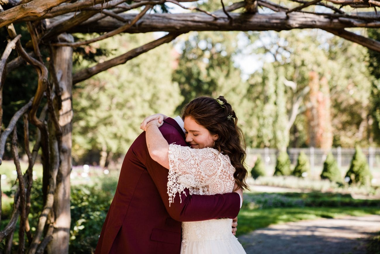 A documentary photograph featured in the best of wedding photography of 2019 showing a bride and groom hugging during their first look at Elm Bank