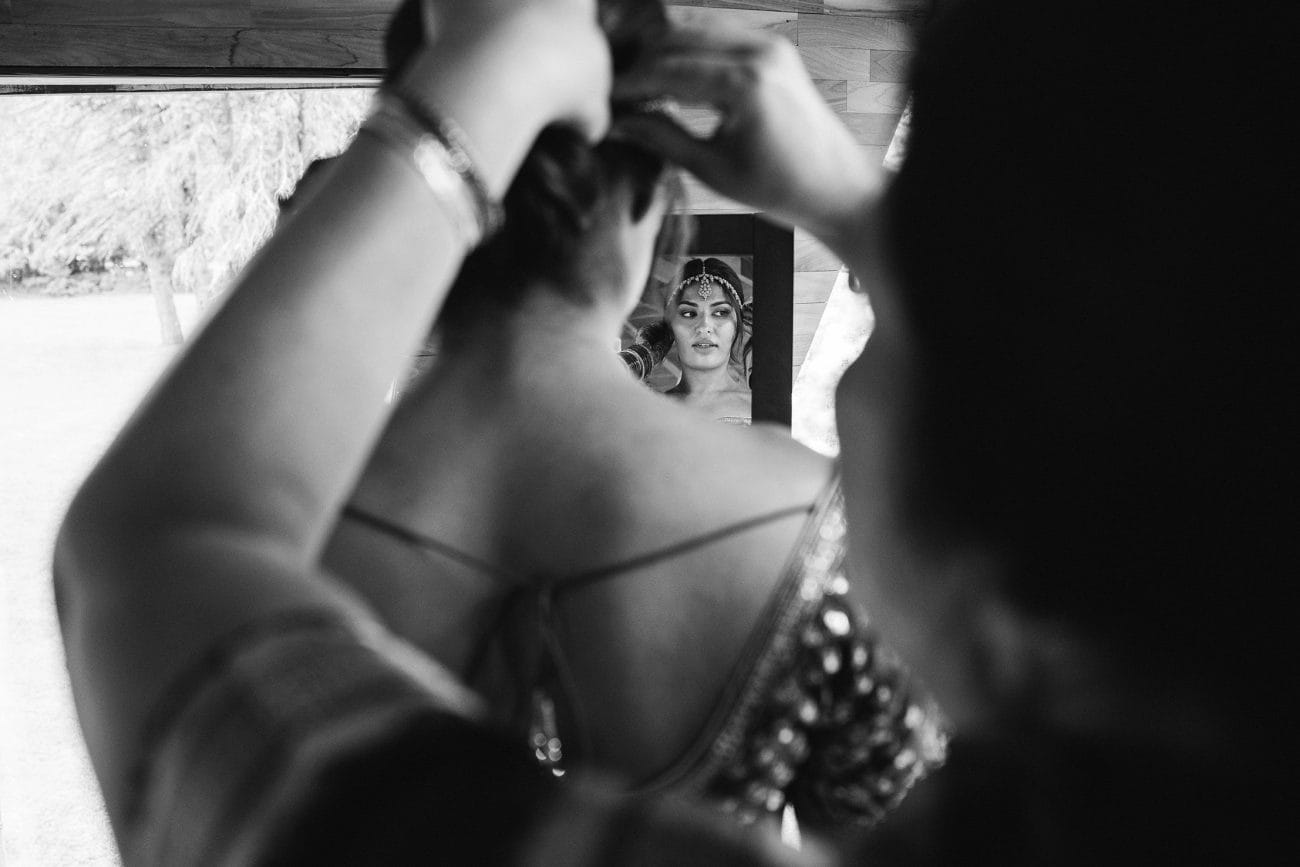 A documentary photograph featured in the best of wedding photography of 2019 showing a bride getting ready for her Indian wedding ceremony