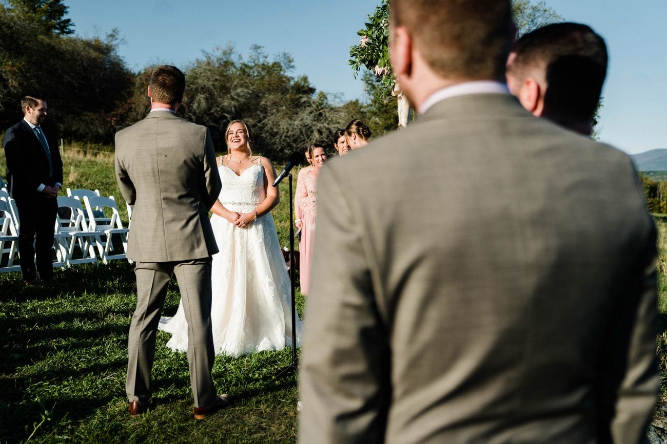 A documentary photograph featured in the best of wedding photography of 2019 showing a bride laughing during her outdoor wedding ceremony