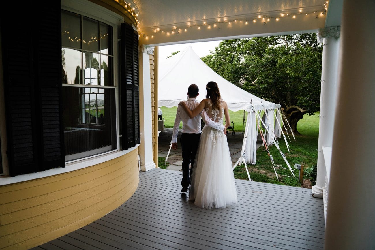 A documentary photograph featured in the best of wedding photography of 2019 showing a bride and groom walking to their reception