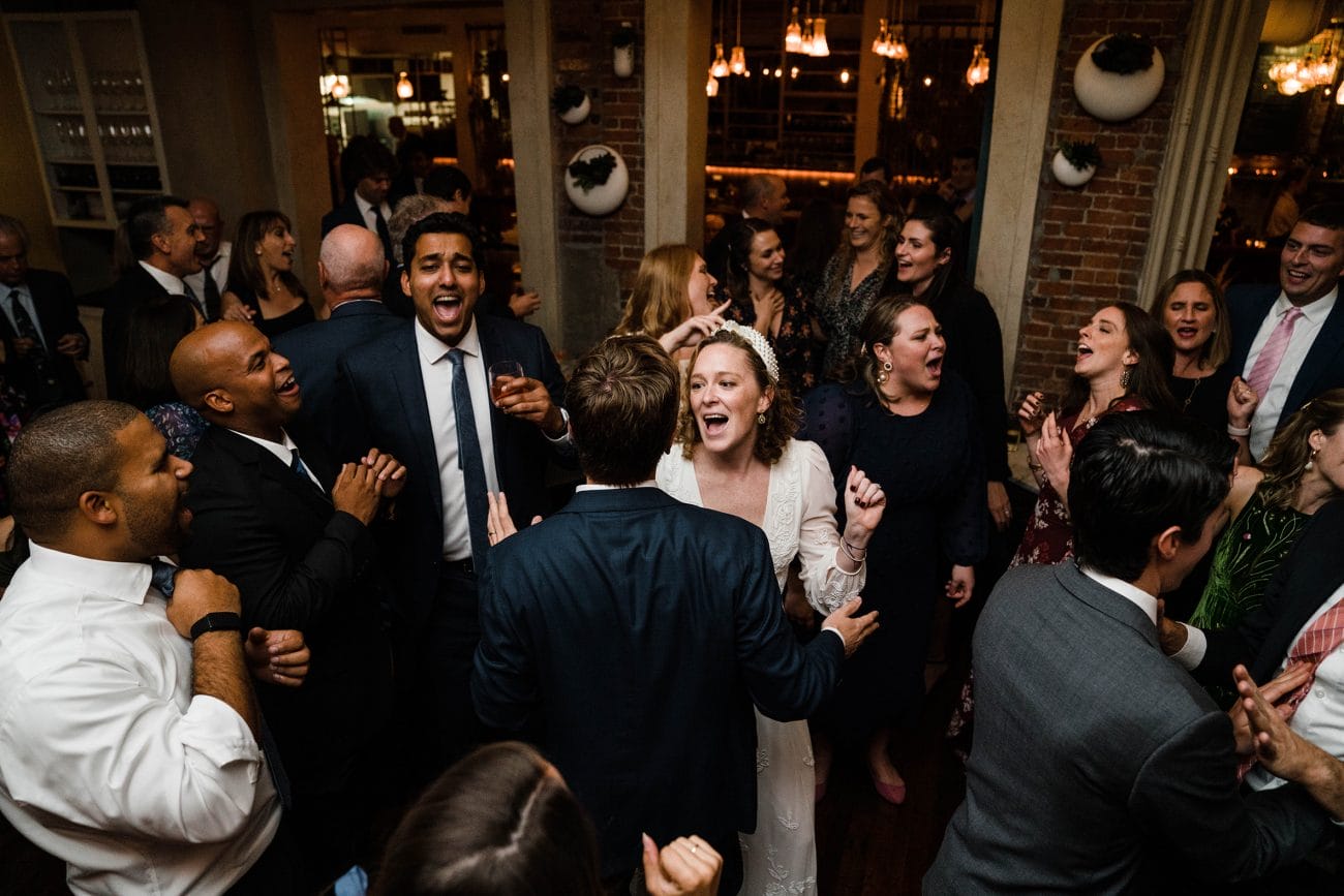 A documentary photograph featured in the best of wedding photography of 2019 showing the wedding guests dancing