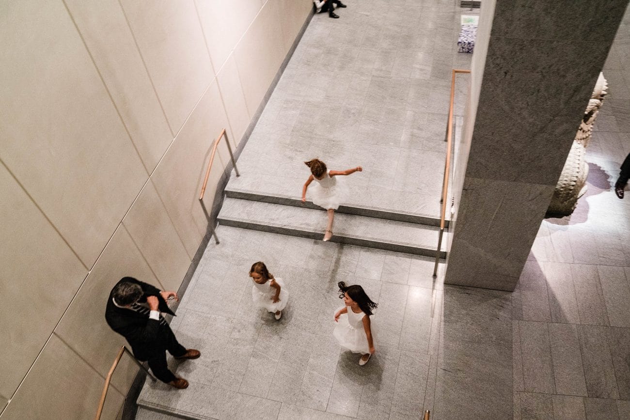 A documentary photograph featured in the best of wedding photography of 2019 showing flower girls running at a wedding reception