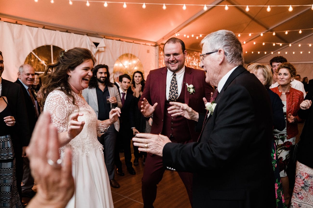 A documentary photograph featured in the best of wedding photography of 2019 showing a bride and groom dancing with her grandpa