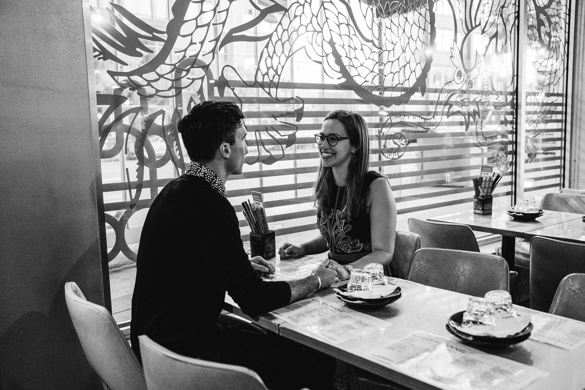 A documentary photograph of a couple having dinner at Myers and Chang during their date night engagement session in Boston