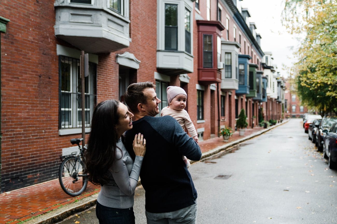 A best of Boston family photograph of a young family walking down their street during an in home family session in Boston