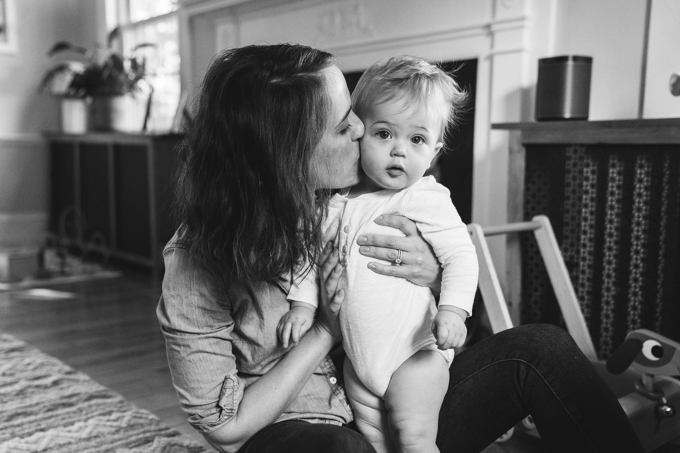 A best of Boston family photograph of mom kissing her baby boy during an in home family session in Boston