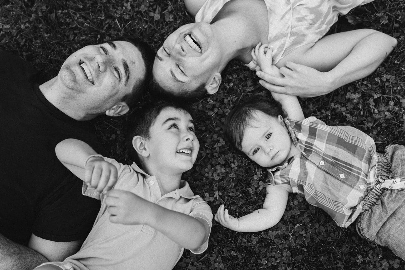 A best of Boston family photograph of a family watching the clouds and laughing during a family session in Boston