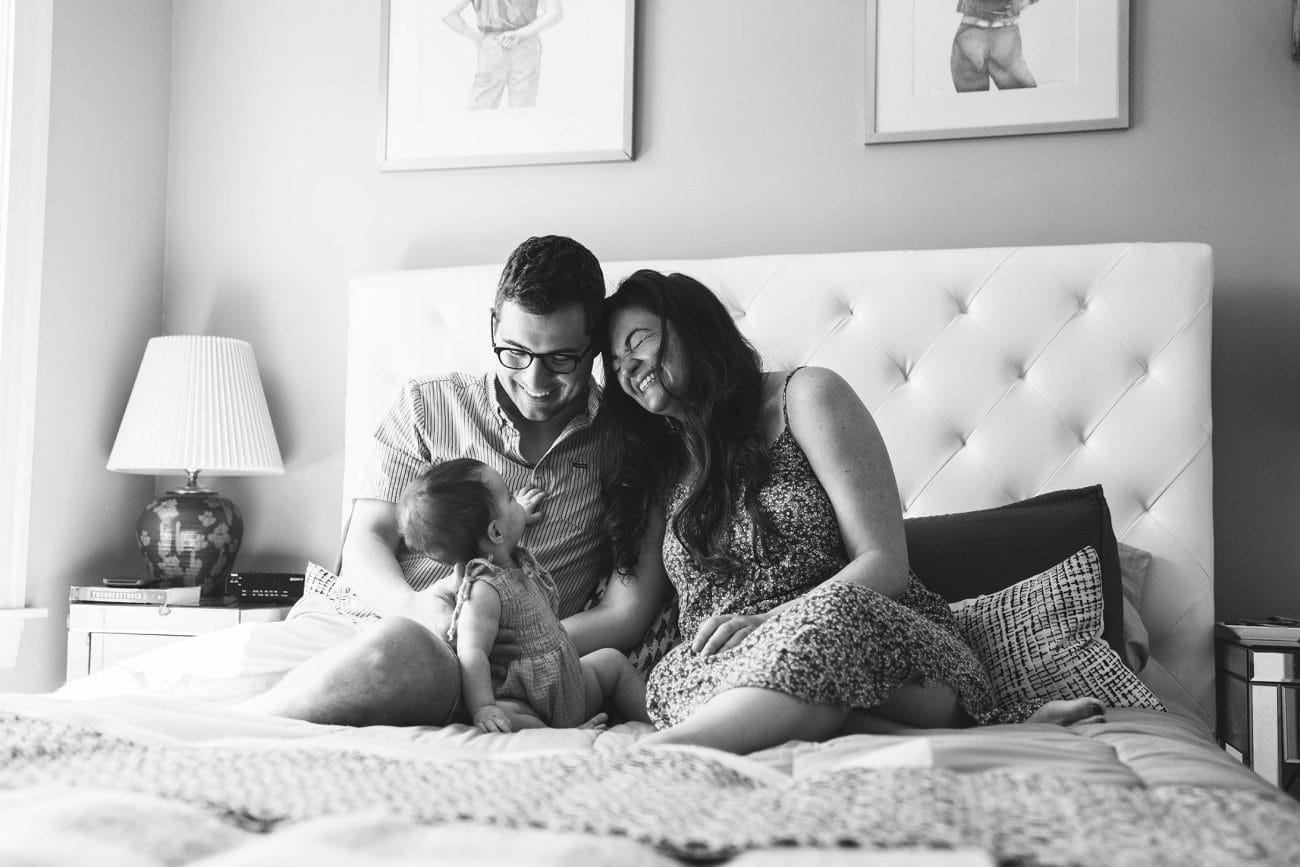 A best of Boston family photograph of a family laughing together in bed during their in home family session in Boston