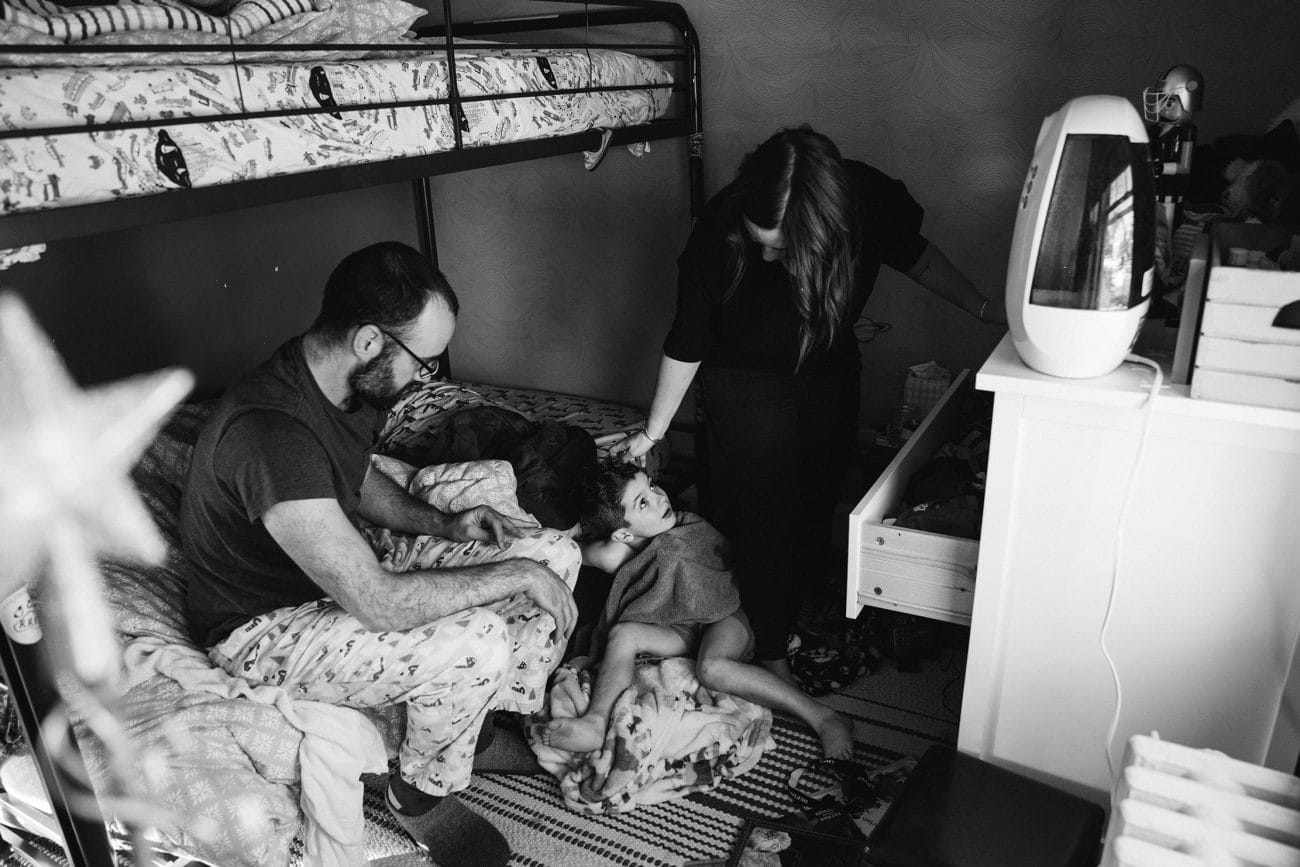 A documentary photograph of family getting ready during their in home family session in Boston