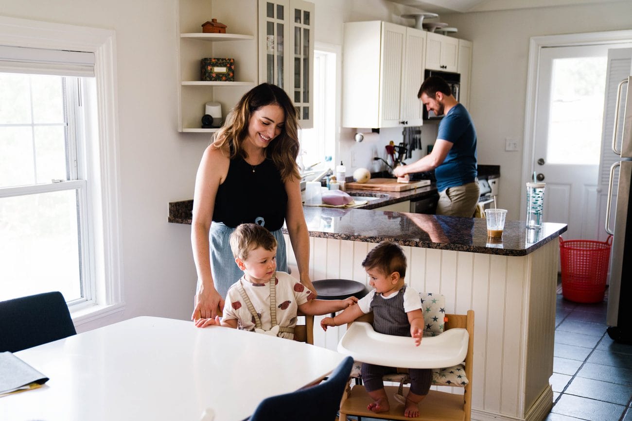 A documentary photograph of family getting ready for lunch during their in home family session in Boston