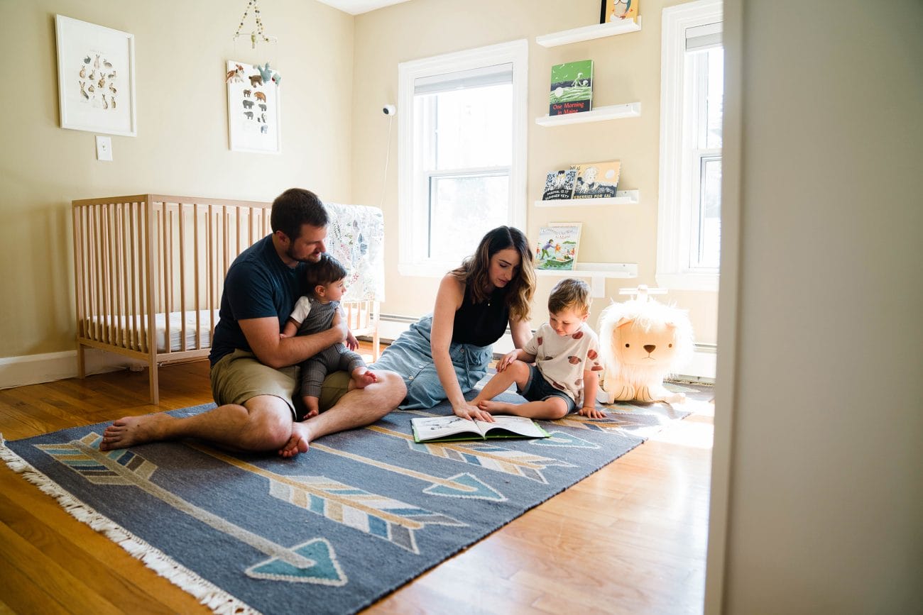 A best of Boston family photograph of a family reading together in their son's room during an in home family session in Boston. 