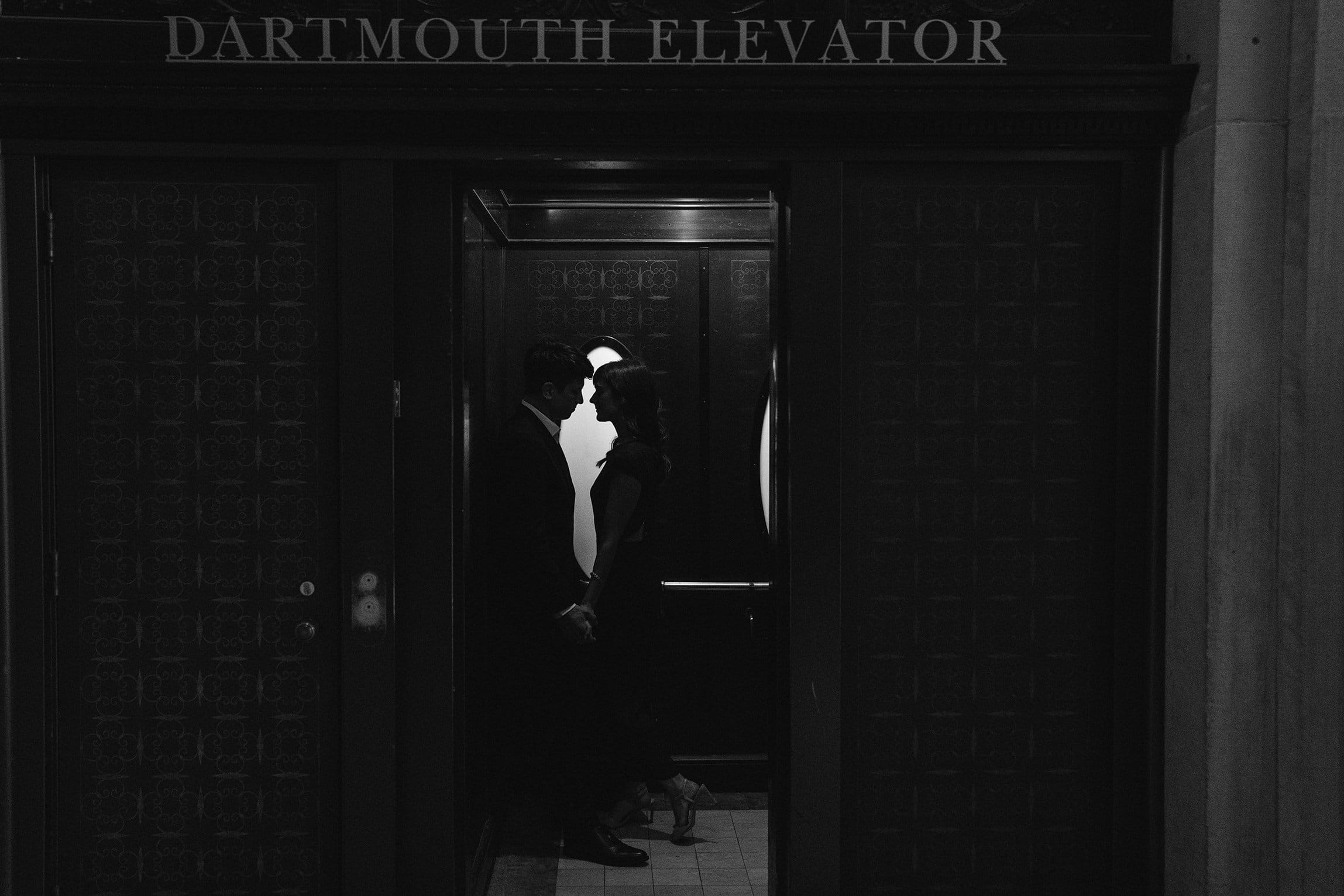 A best of Boston engagement photograph of a couple sharing an intimate moment at the Boston Public Library. 