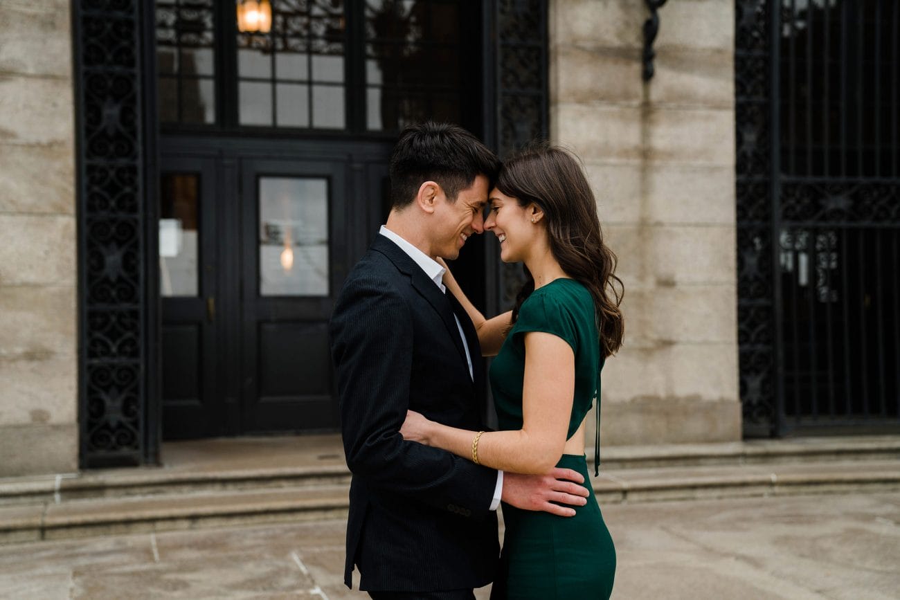 A best of Boston engagement session of a couple sharing an intimate moment outside the Boston Public Library
