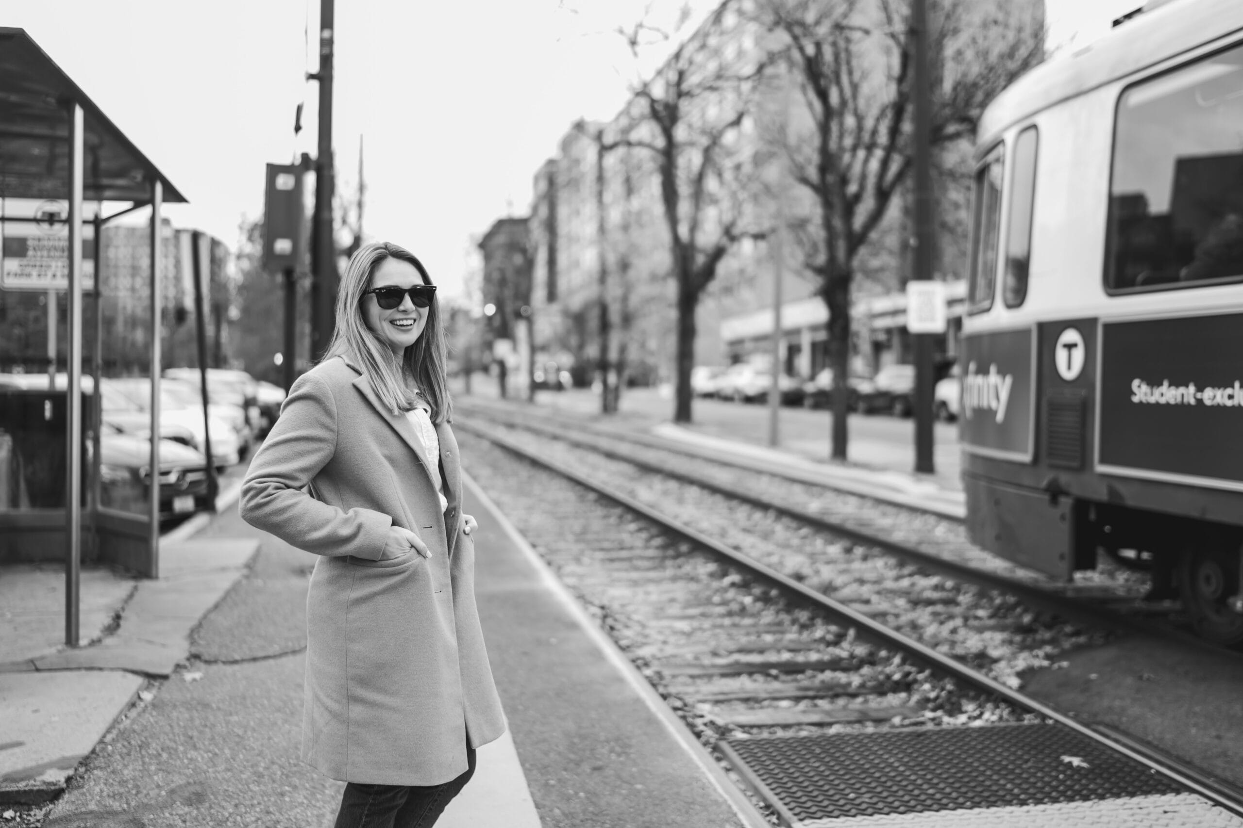 A Boston Branding Photograph of a small business owner standing by the green line in Brookline, MA