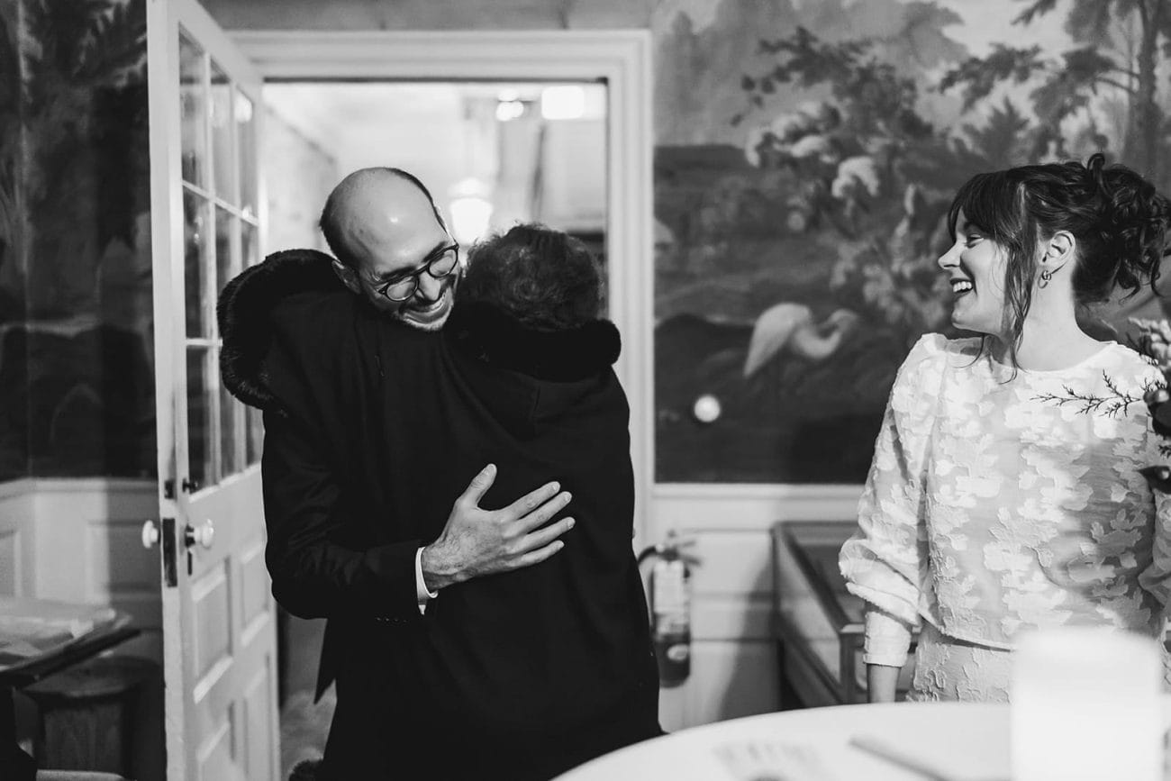 A documentary photograph of a groom hugging his mom before their Loring Greenough House Wedding. 
