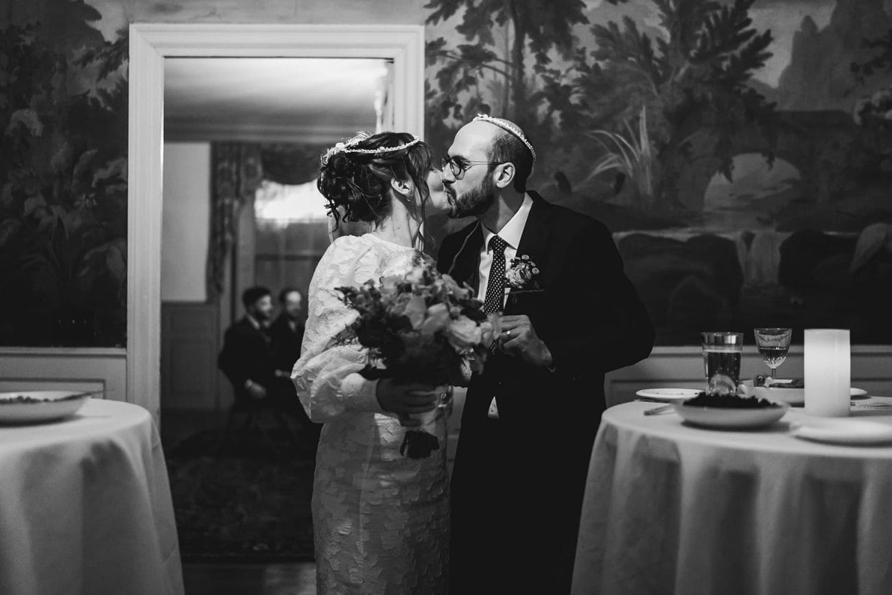 A documentary photograph of a bride and groom hugging during their Loring Greenough House Wedding. 