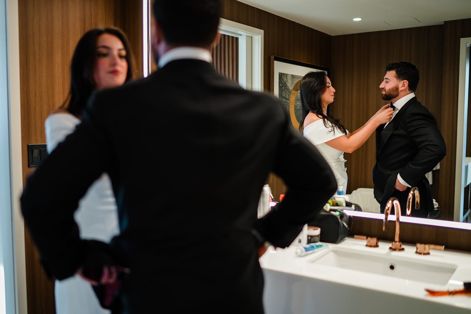 A documentary photograph of a bride and groom getting ready together at Omni Seaport before their Boston City Hall ceremony and intimate wedding at Mooo.... Seaport.
