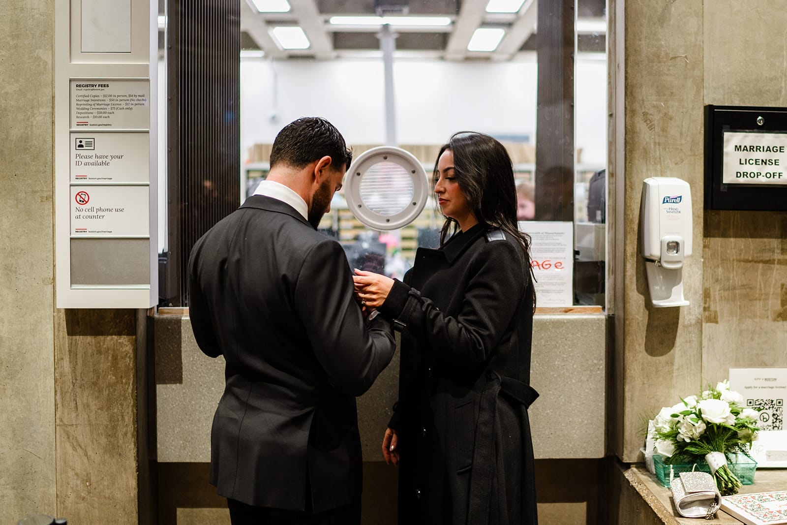 A documentary photograph of a bride and groom registering for their marriage at Boston City Hall before their wedding celebration at Mooo.... Seaport. 