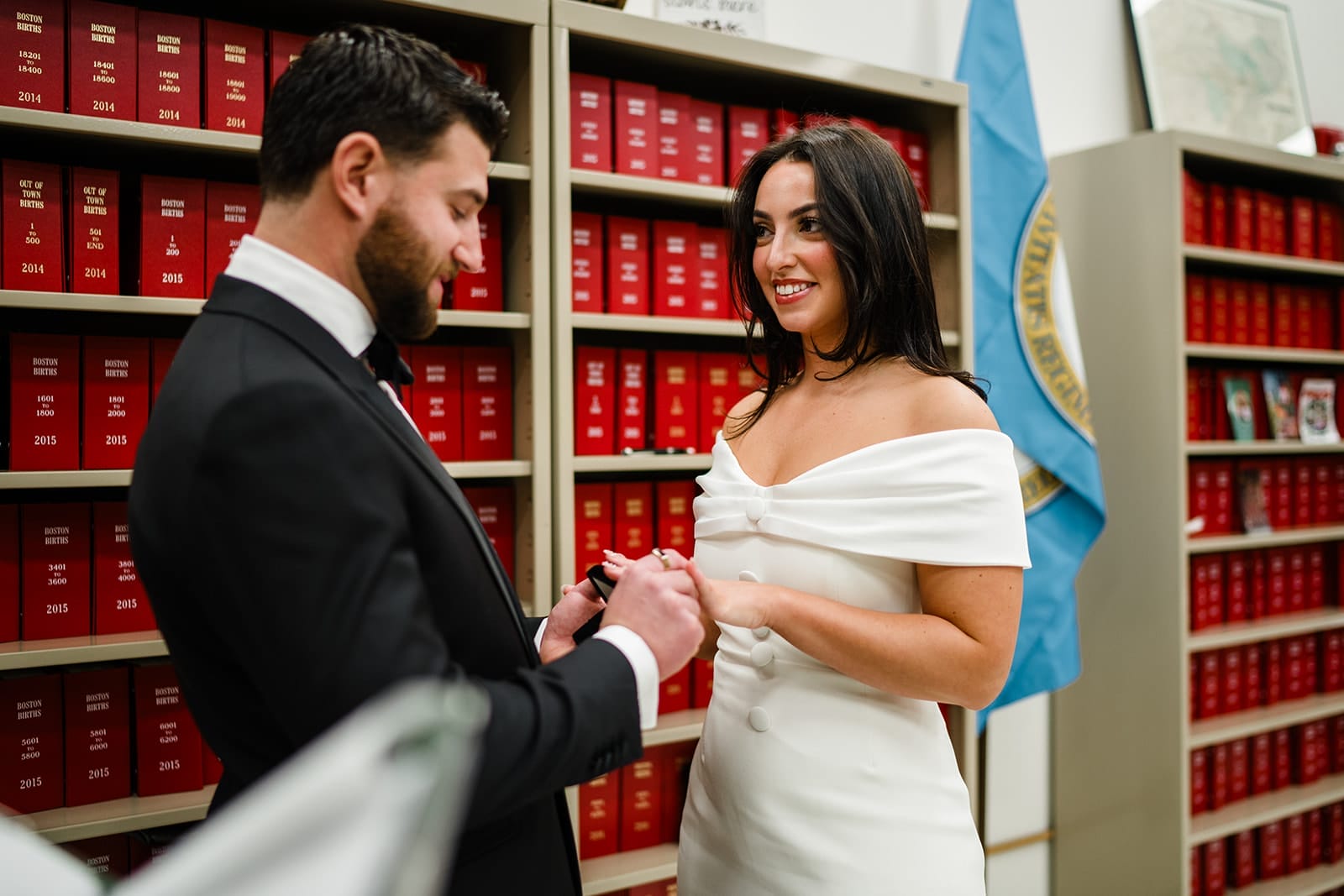 A documentary photograph of a bride and groom getting married at Boston City Hall before their wedding celebration at Mooo.... Seaport. 