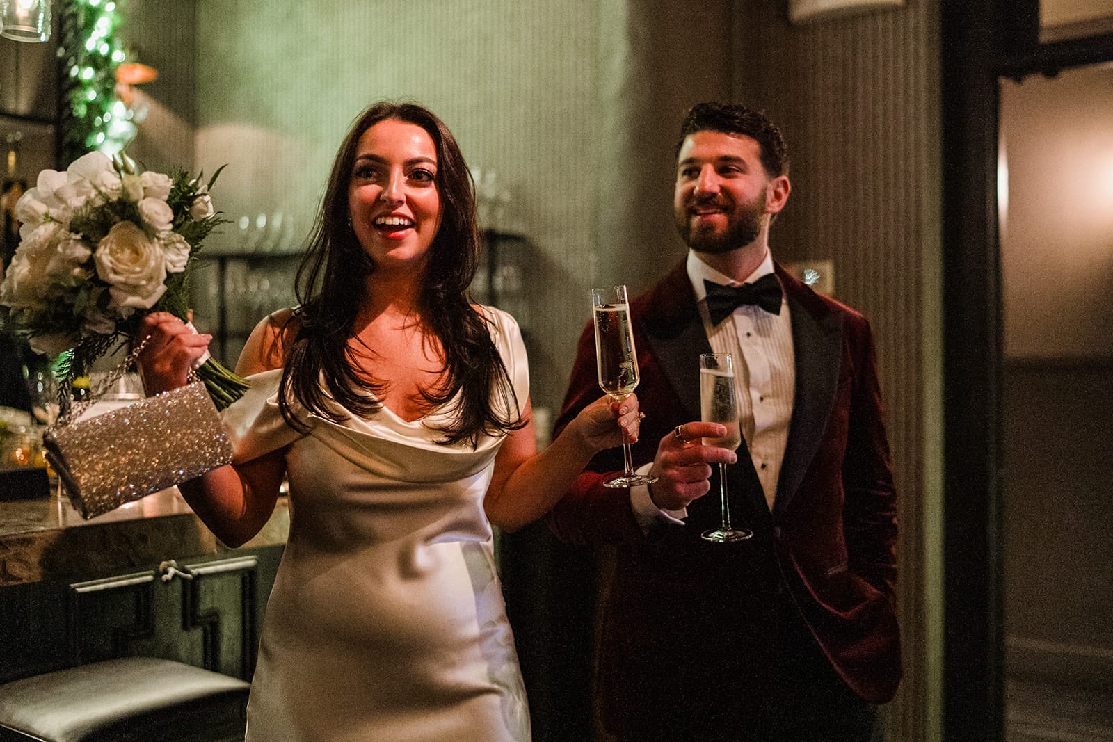 A documentary photograph of a bride and groom entering their intimate wedding at Mooo.... Seaport.