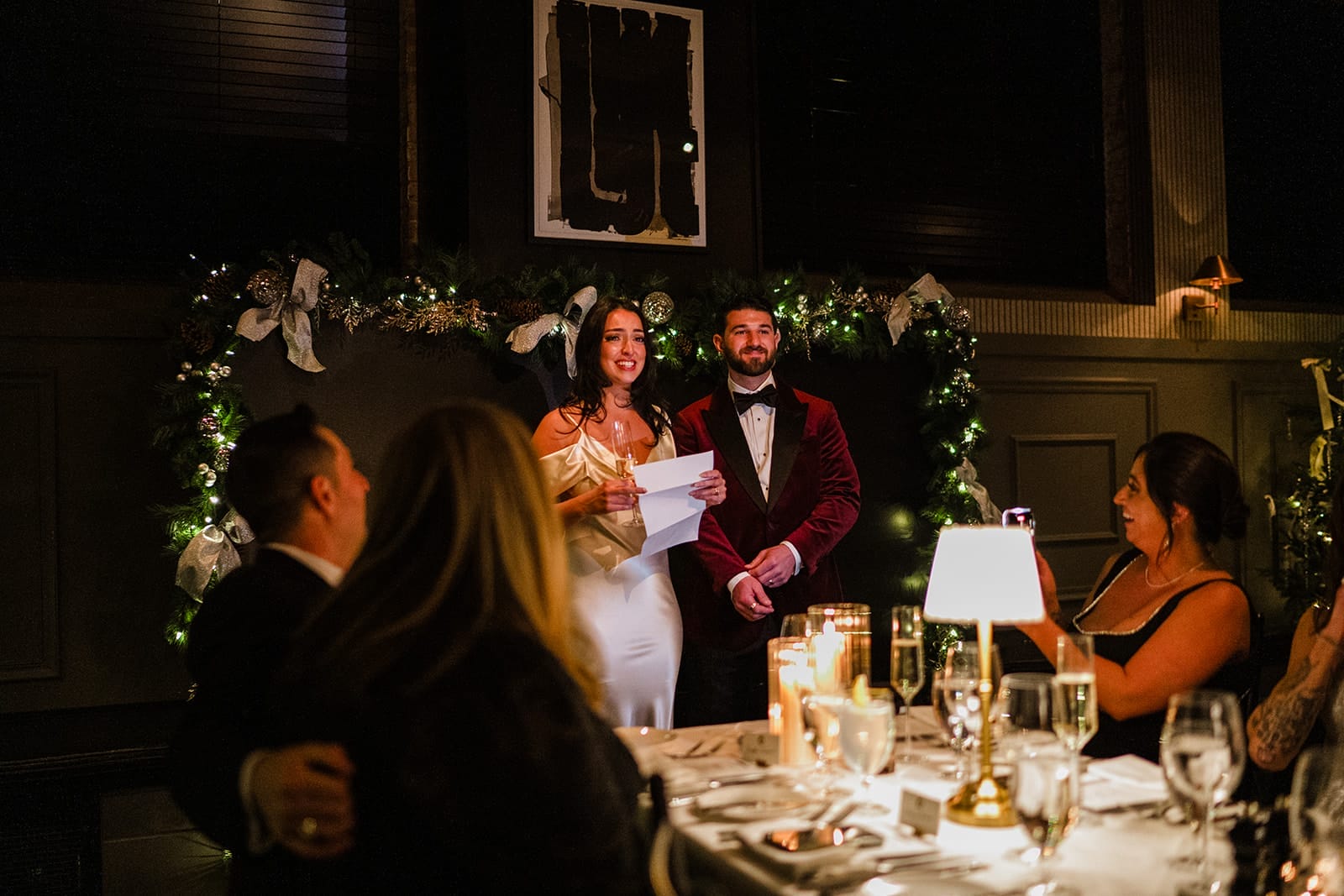 A documentary photograph of a bride and groom giving a toast during their intimate wedding at Mooo.... Seaport.