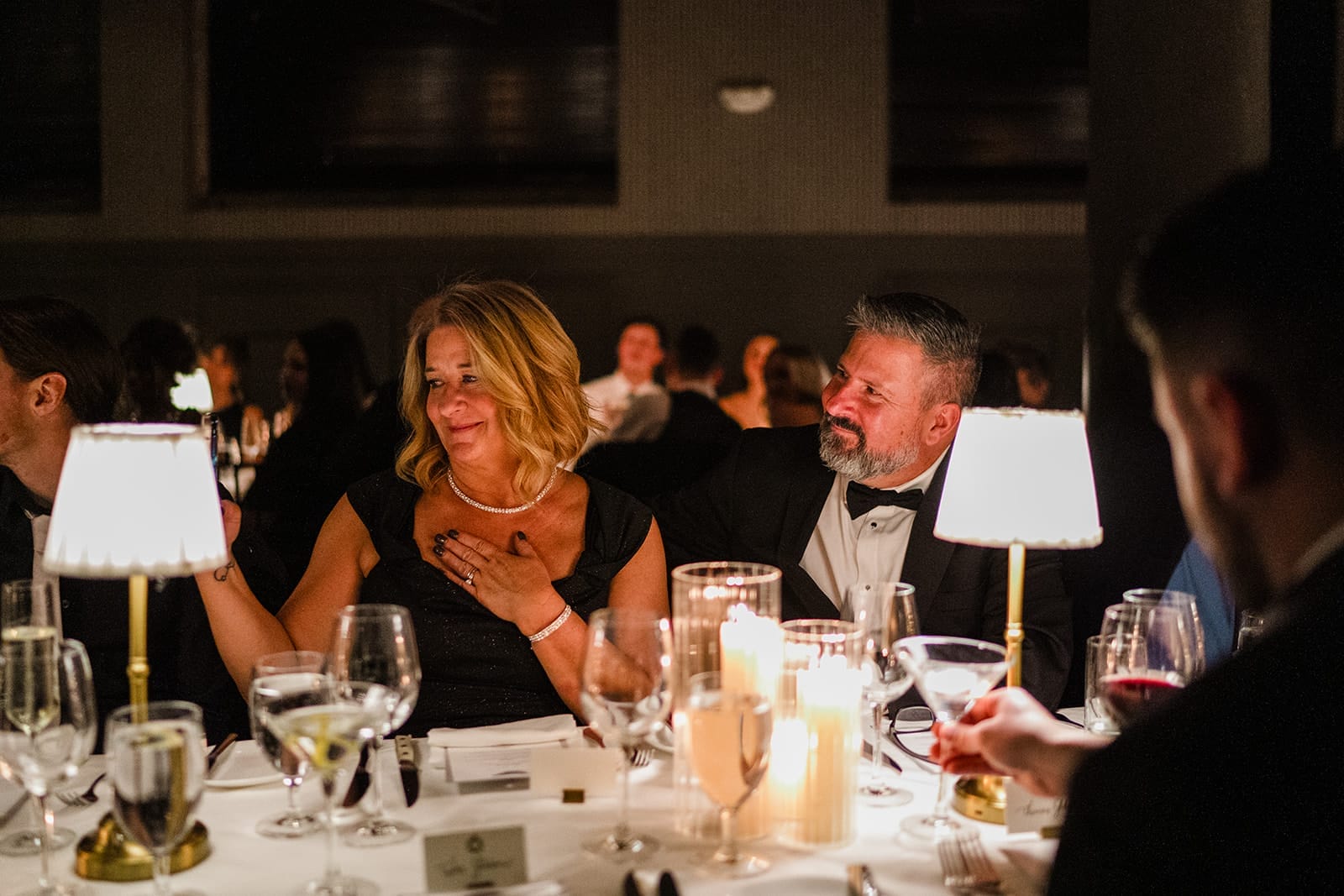 A documentary photograph of the groom's parents reacting to the toasts during their son's wedding celebration at Mooo.... Seaport.