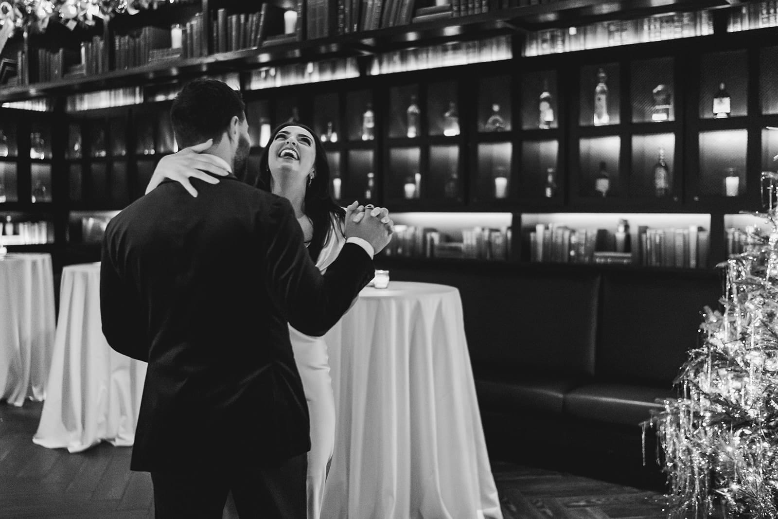 A documentary photograph of a bride and groom dancing during their wedding celebration at Mooo.... Seaport.