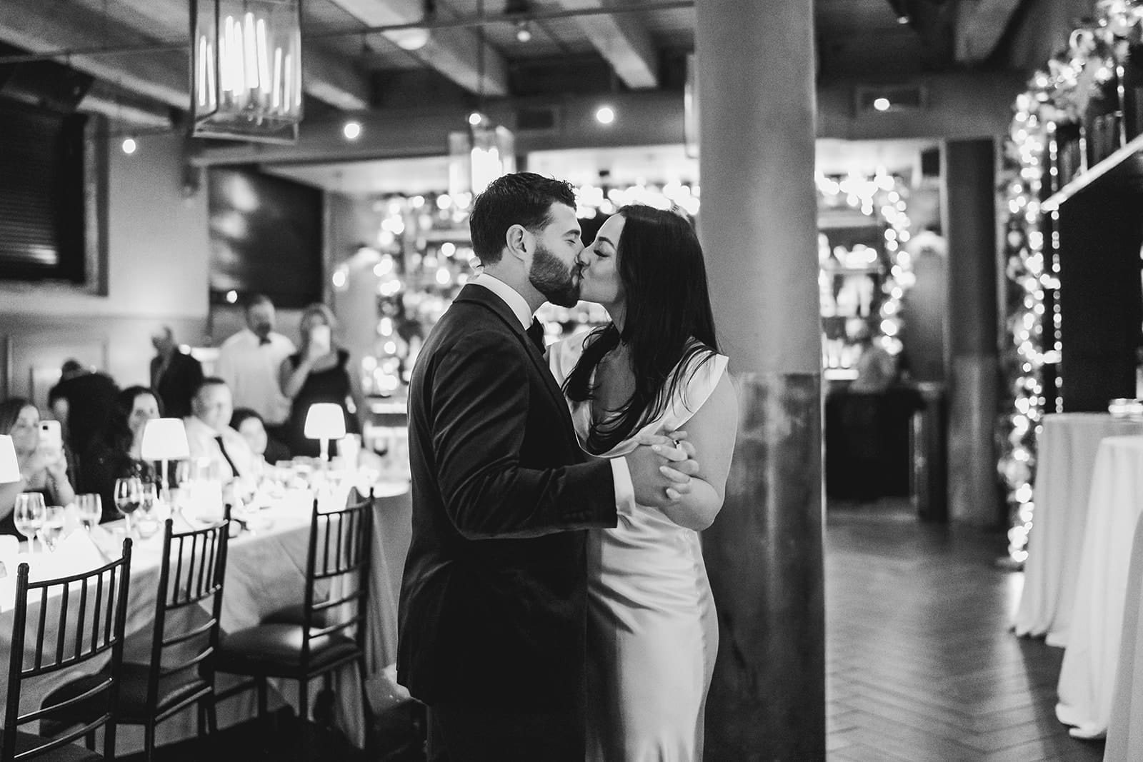 A documentary photograph of a bride and groom dancing during their intimate wedding at Mooo.... Seaport.