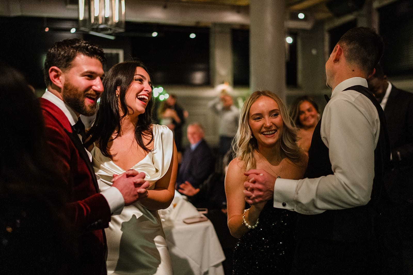 A documentary photograph of a bride and groom dancing during their wedding celebration at Mooo.... Seaport.