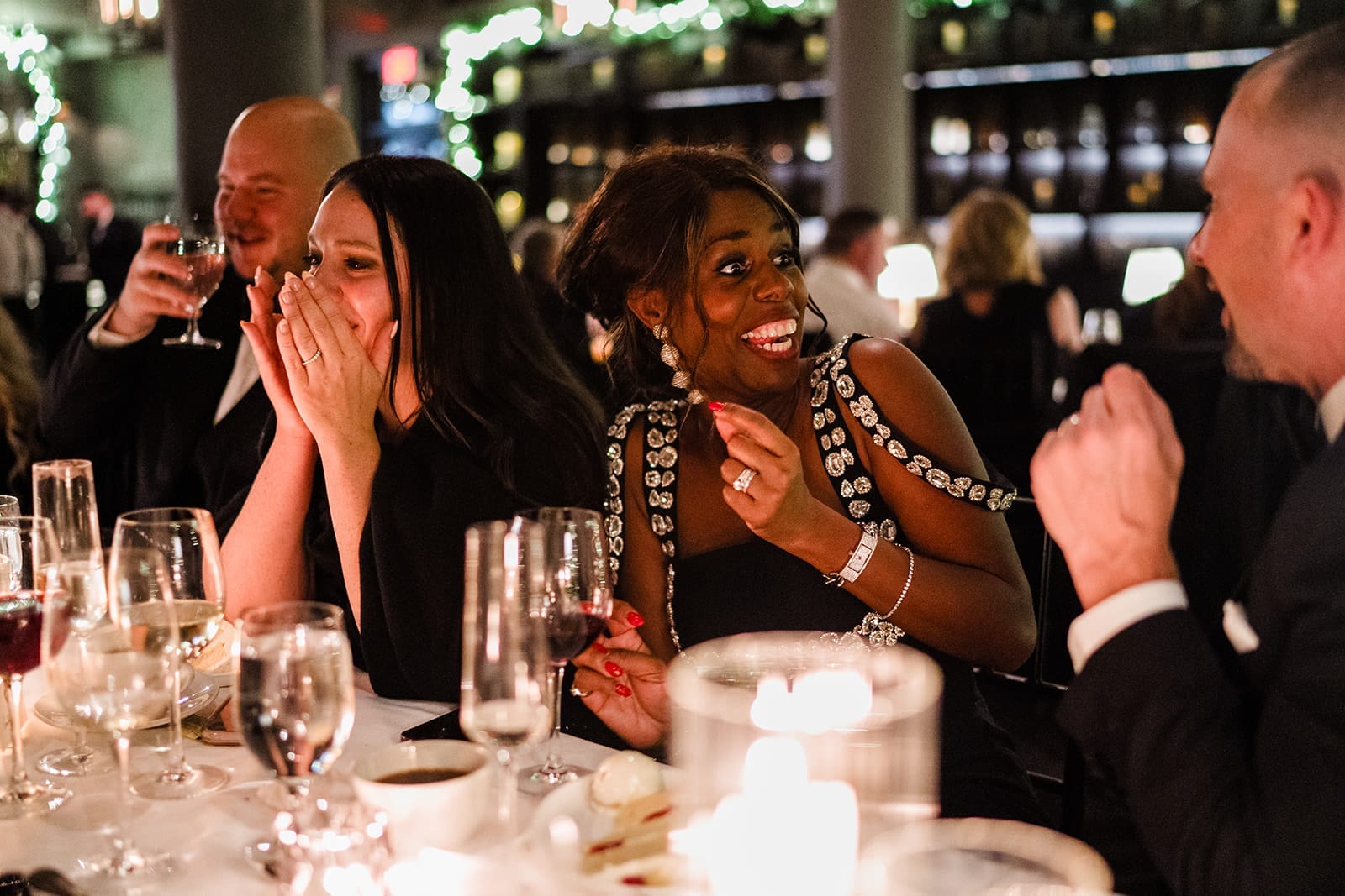 A documentary photograph of guests talking at dinner during a intimate wedding at Mooo.... Seaport.