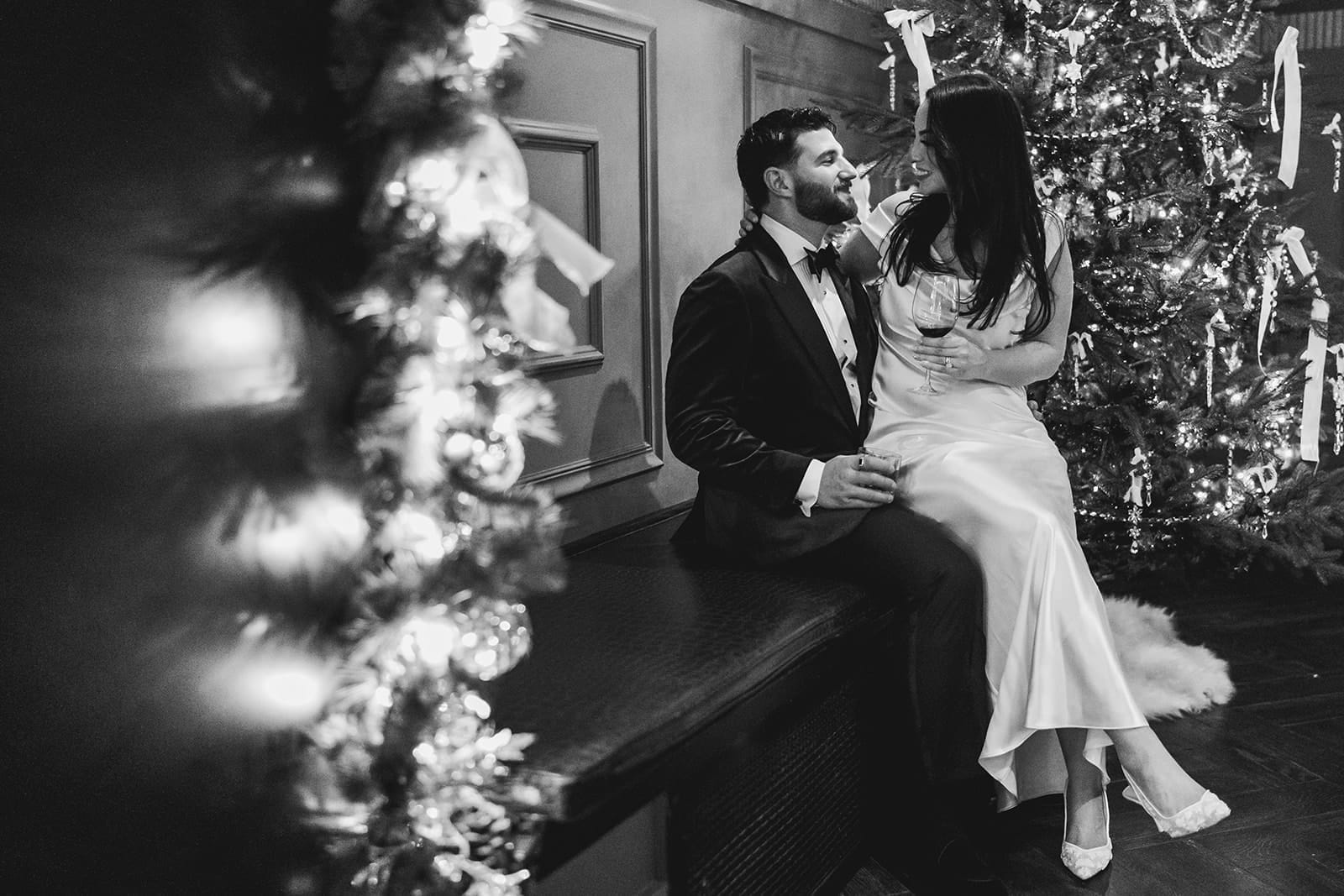 A documentary photograph of a bride and groom sitting together during their intimate wedding at Mooo.... Seaport.