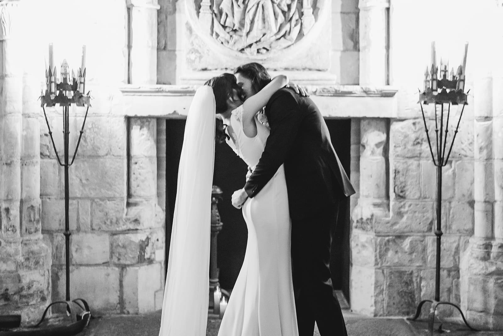 A documentary photograph of a bride and groom kissing during their intimate Worcester Art Museum Wedding Ceremony