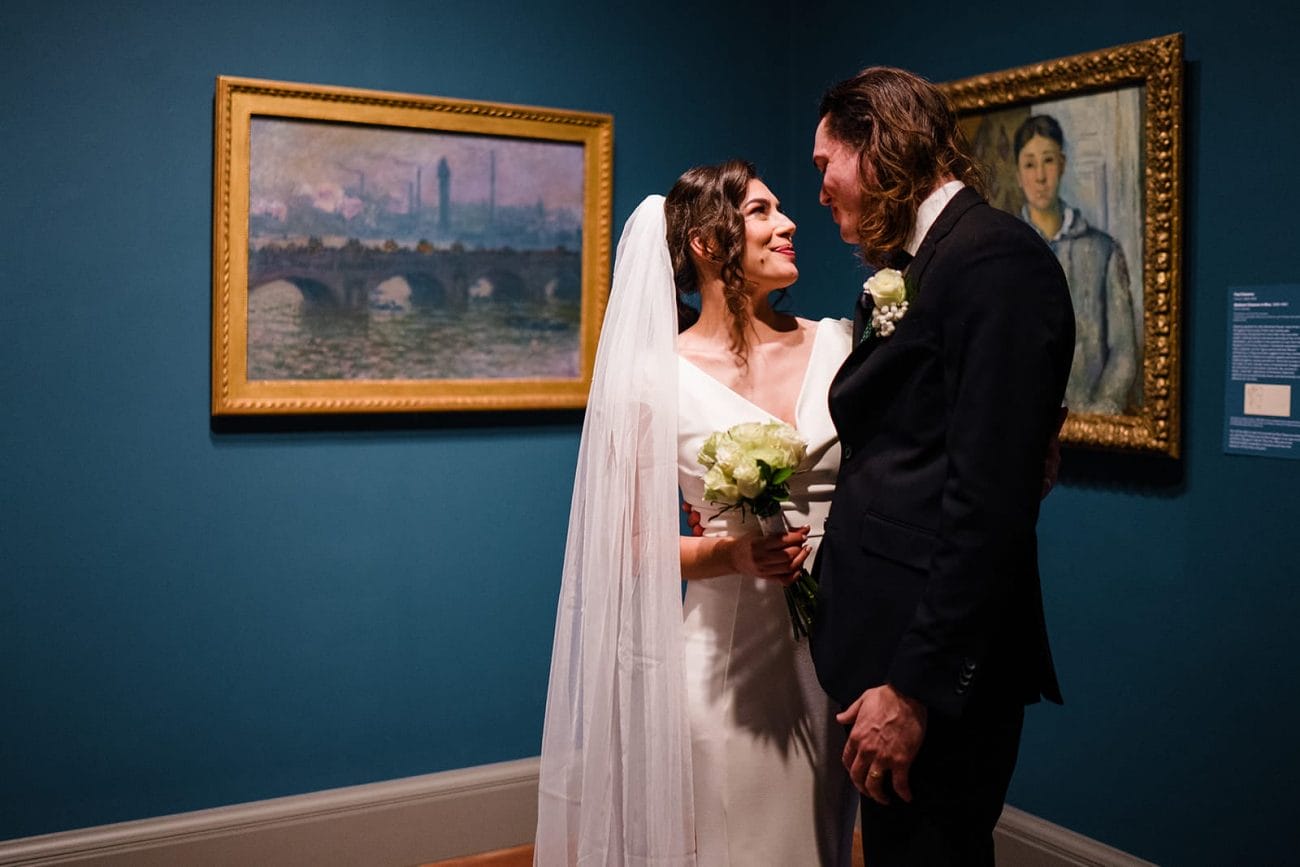 A documentary photograph of a bride and groom spending time in the art galleries during their intimate Worcester Art Museum Wedding 