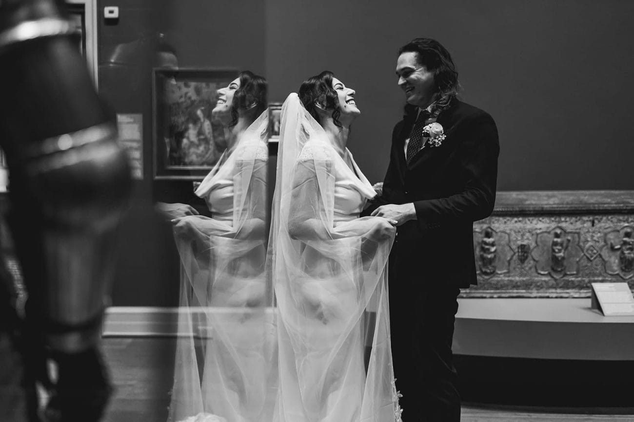A documentary photograph of a bride and groom spending time in the art galleries during their intimate Worcester Art Museum Wedding 