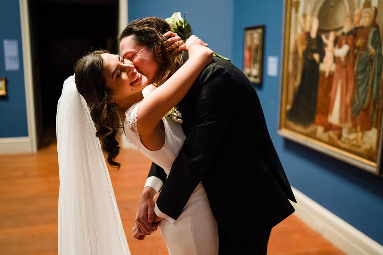 A documentary photograph of a bride and groom spending time in the art galleries during their intimate Worcester Art Museum Wedding 