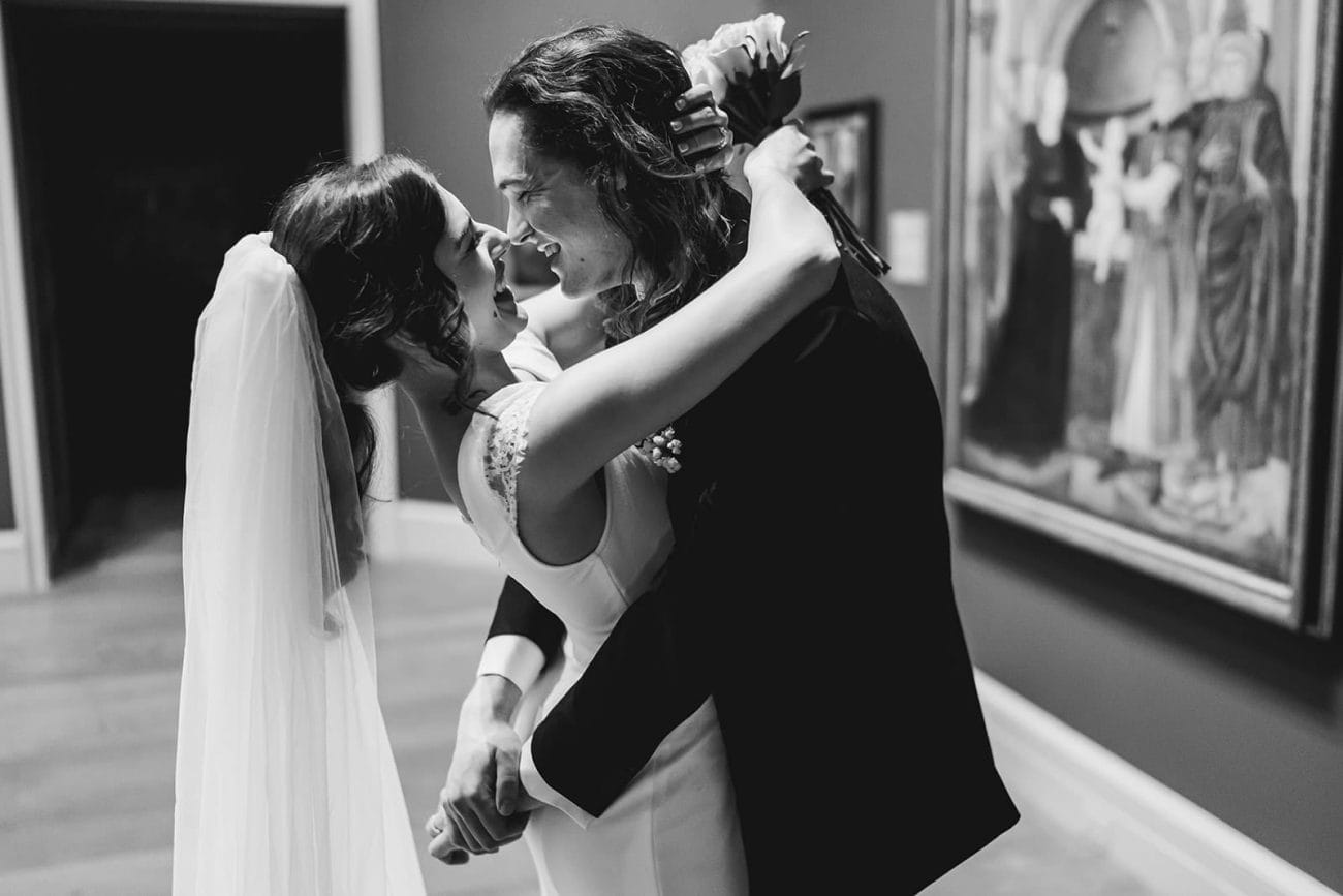 A documentary photograph of a bride and groom spending time in the art galleries during their intimate Worcester Art Museum Wedding 