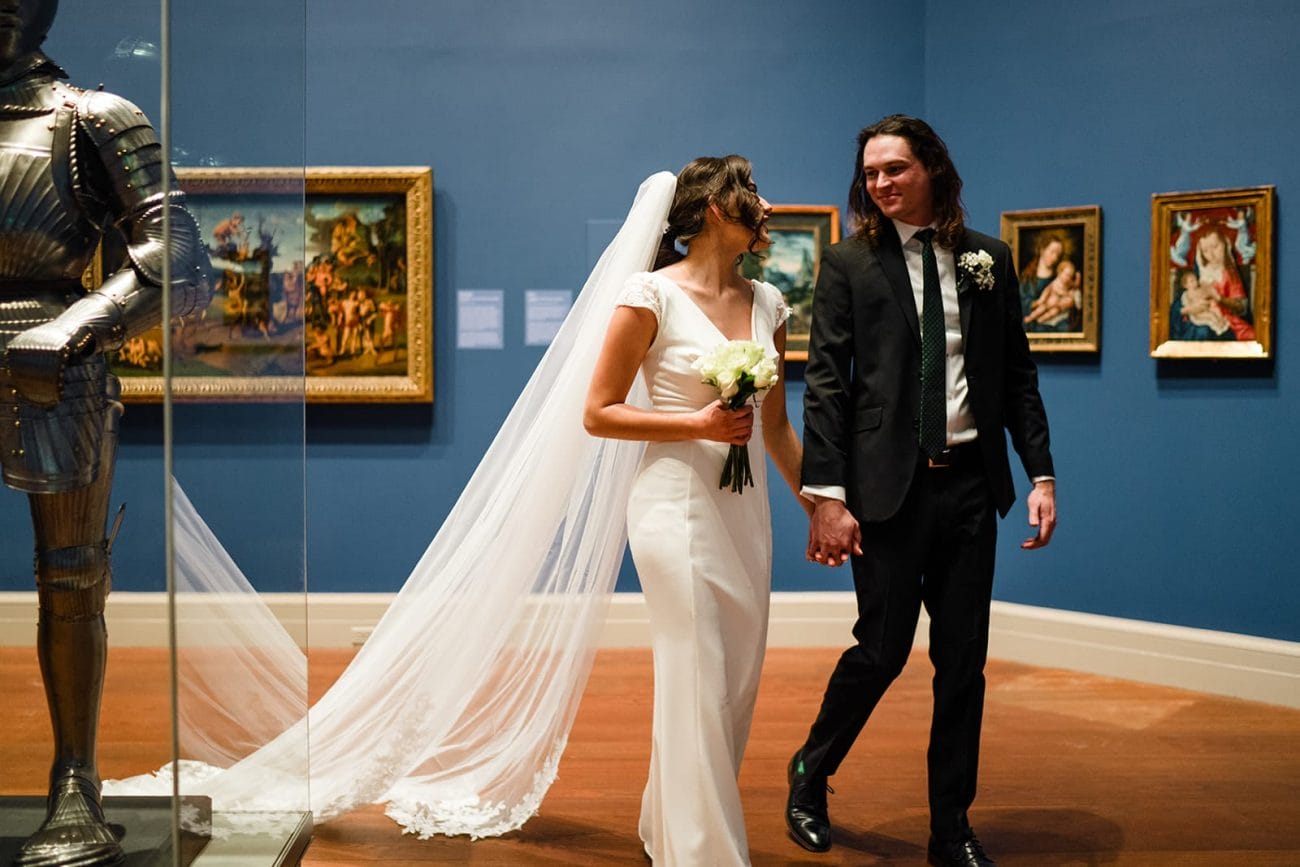 A documentary photograph of a bride and groom spending time in the art galleries during their intimate Worcester Art Museum Wedding 
