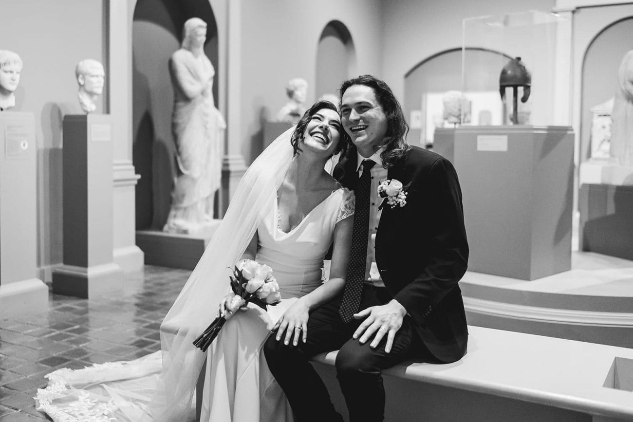 A documentary photograph of a bride and groom spending time in the art galleries during their intimate Worcester Art Museum Wedding 