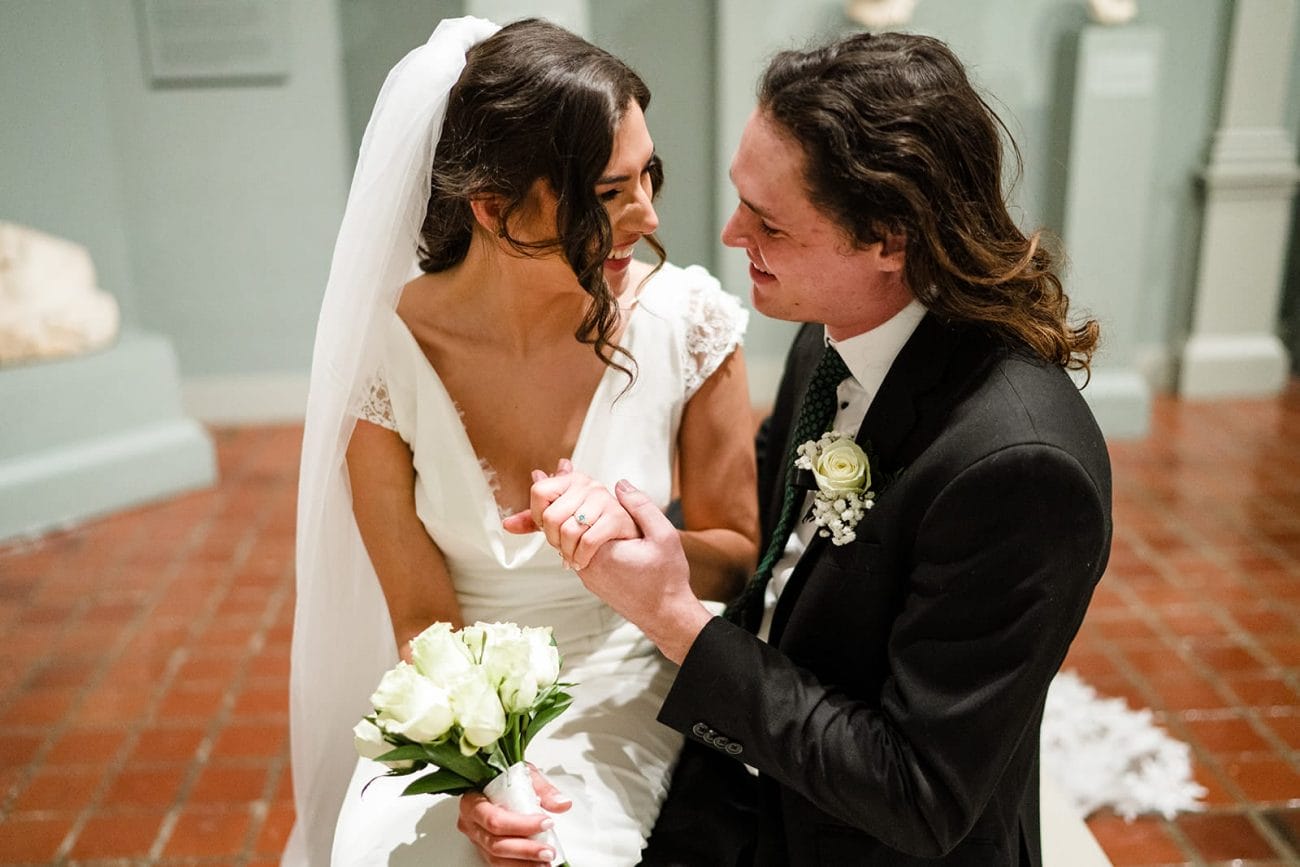 A documentary photograph of a bride and groom spending time in the art galleries during their intimate Worcester Art Museum Wedding 