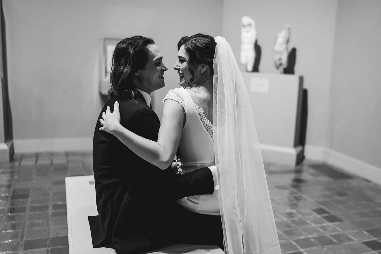 A documentary photograph of a bride and groom spending time in the art galleries during their intimate Worcester Art Museum Wedding 