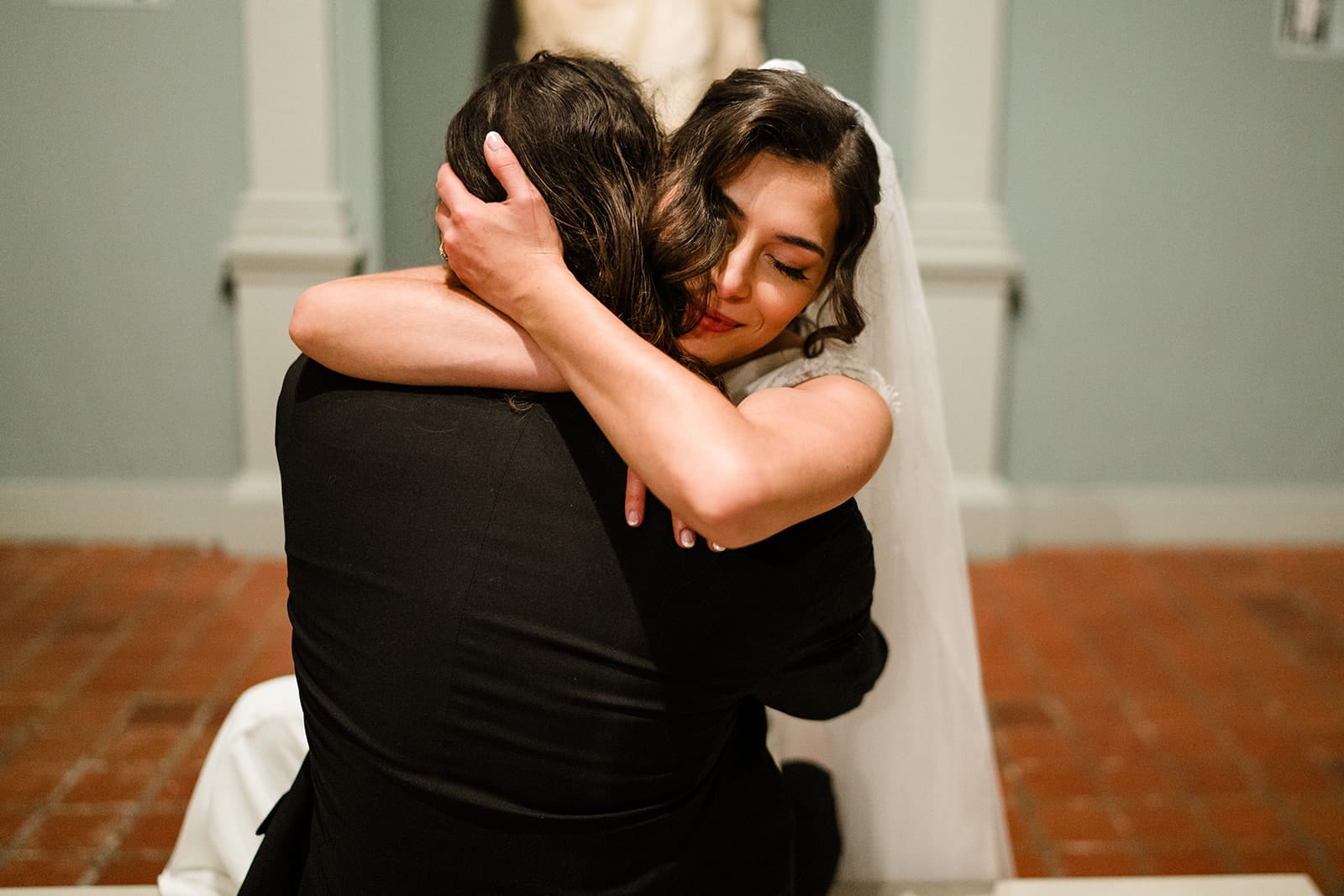 A documentary photograph of a bride and groom spending time in the art galleries during their intimate Worcester Art Museum Wedding