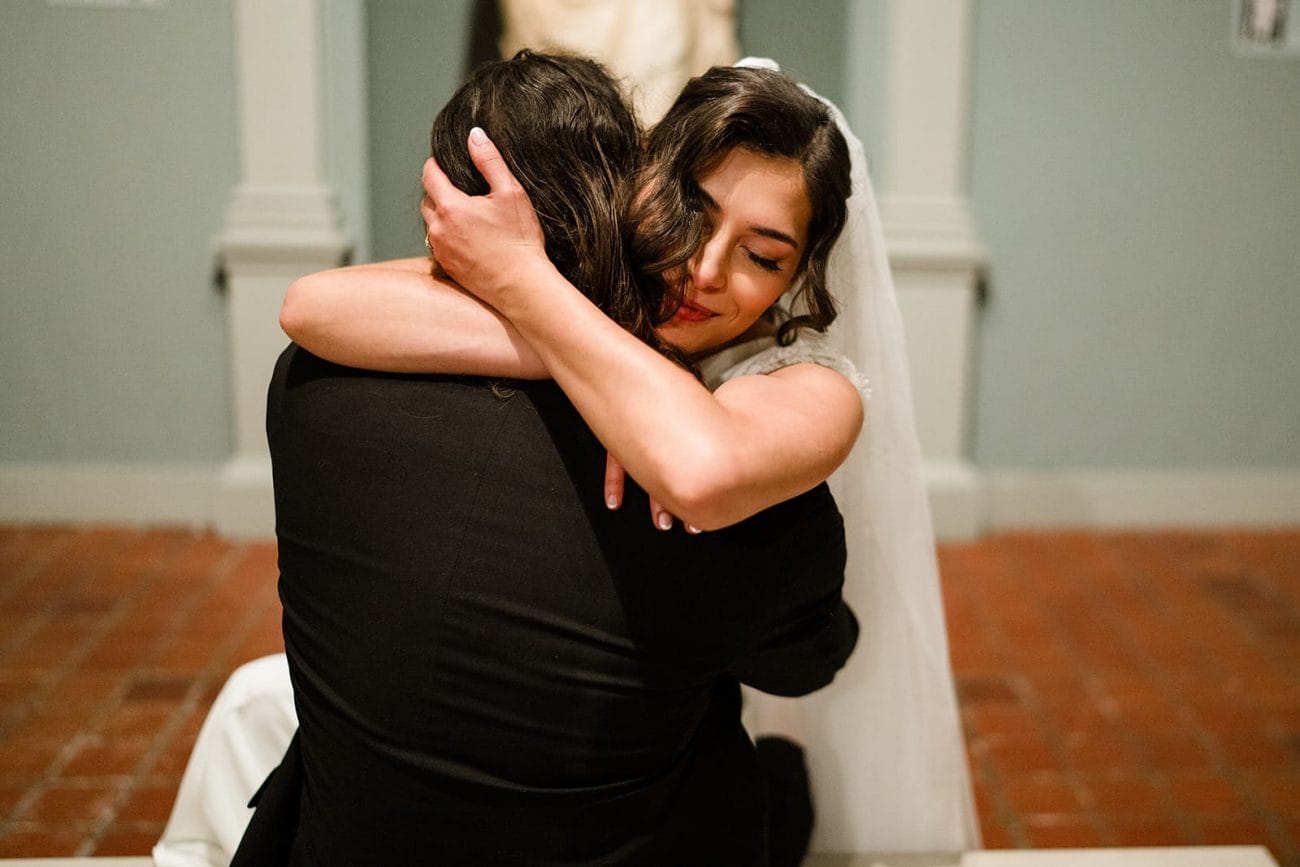 A documentary photograph of a bride and groom spending time in the art galleries during their intimate Worcester Art Museum Wedding 