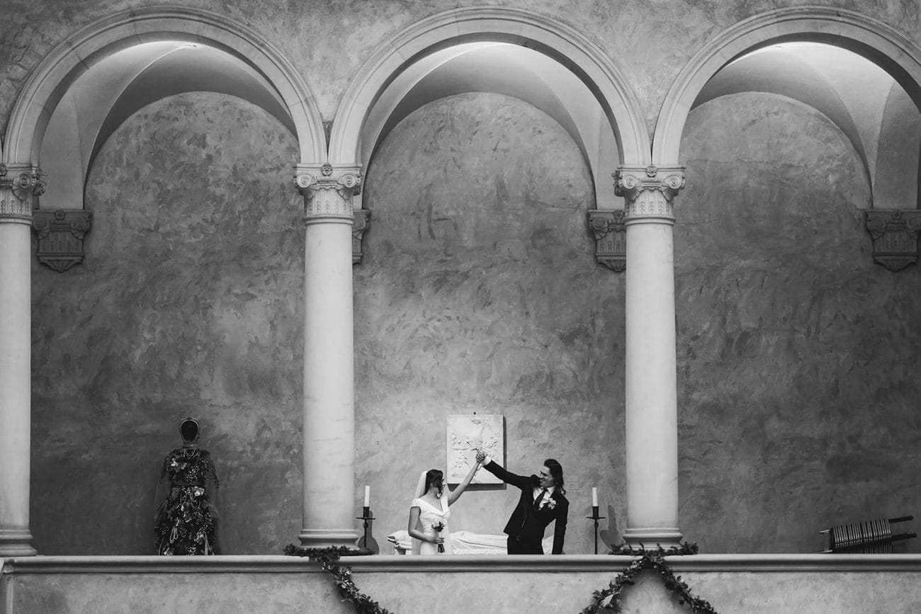 A documentary photograph of a bride and groom spending time in the art galleries during their intimate Worcester Art Museum Wedding 